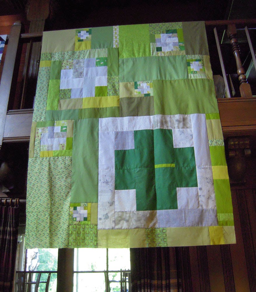 green cross quilt top hanging
