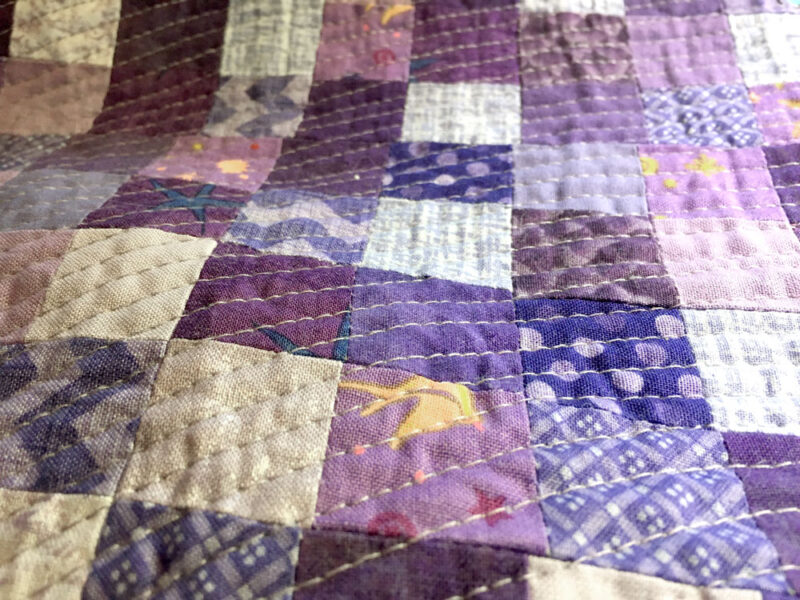 quilting on a purple quilt top