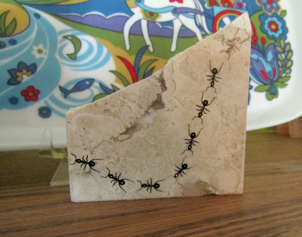 Screen print of ants on a broken stone tile